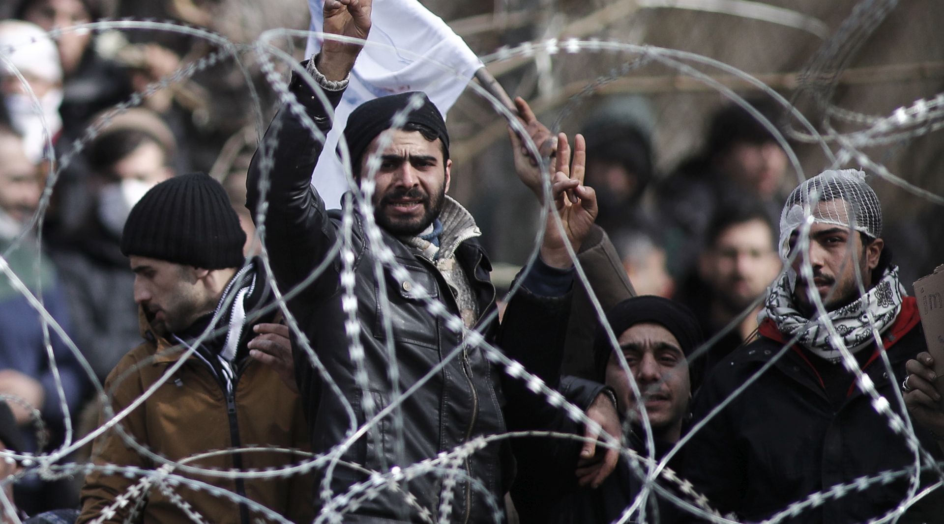 epa08264367 Refugees and migrants gather on the Turkish side of the closed Kastanies border crossing, on the borderline between Greece and Turkey, near the Evros River, in an attempt to cross into Greece, 02 March 2020. Thousands of refugees and migrants are gathering on the Turkish side of the border with Greece with the intent to cross into the European Union following the Turkish government's decision to loosen controls on migrant flows after the death of 33 Turkish soldiers killed in an attack in Idlib, Syria on 27 February.  EPA/DIMITRIS TOSIDIS