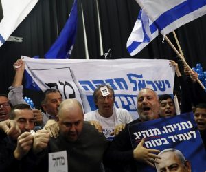 epa08265527 Supporters of Israeli Prime Minister and Chairman of the Likud Party Benjamin Netanyahu (not pictured) celebrate at the Likud party final election event after early exit polls in the third parliament election in one year, in Tel Aviv, Israel, 03 March 2020. Exit polls indicate that Benjamin Netanyahu's Likud Party will be able to form a government with a 60-seat bloc over opposition leader Benny Gantz's Blue and White Party.  EPA/ATEF SAFADI