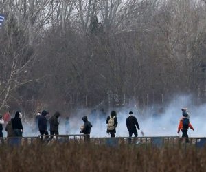 epa08268550 Migrants run from tear gas employed by Greek police officers as they attempt to cross the closed-off Turkish-Greek border in a bid to reach European soil, in Edirne, Turkey, 04 March 2020. Thousands of refugees and migrants are gathering on the Turkish side of the border with Greece with the intention of crossing into the European Union following the Turkish government's decision to loosen controls on migrant flows after the death of 33 Turkish soldiers killed in an attack in Idlib, Syria, on 27 February 2020.  EPA/ERDEM SAHIN