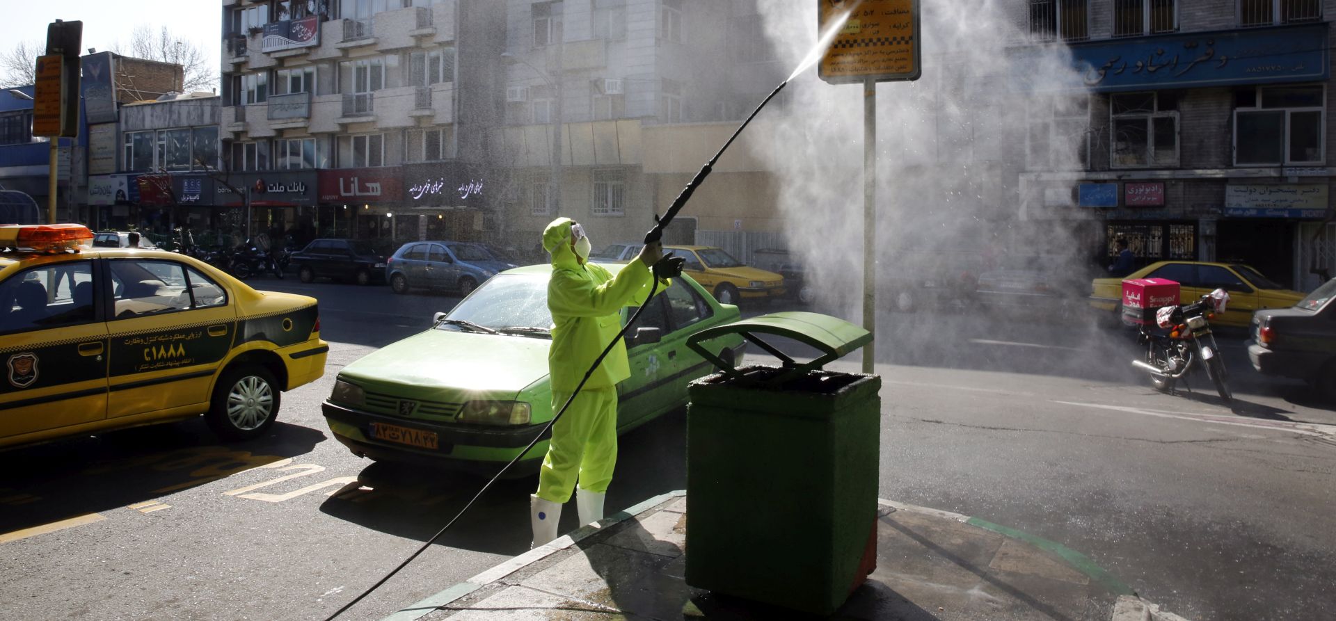 epa08271341 Members of Iranian fire fighters and municipality workers disinfect the streets of the capital city on Tehran, Iran, 05 March 2020. According the last report by the Ministry of Health, 2922 people diagnosed with the Covid-19 coronavirus and 92 people have died in Iran.  EPA/ABEDIN TAHERKENAREH