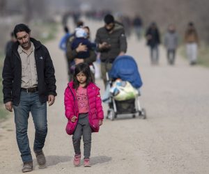 epa08280130 Migrants and refugees walk towards the Greek border with their belongings near the Pazarkule border gate in Edirne, Turkey, 09 March 2020. Some 10,000 migrants, mostly from Syria, have reached Turkey's land borders with EU states Greece and Bulgaria with the intention of crossing into the European Union.  EPA/TOLGA BOZOGLU