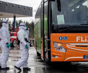 epa08281126 Police officers in protective suits talk with bus driver at the Rozvadov border crossing from the Germany side near city of Rozvadov, Czech Republic, 09 March 2020. The Covid-19 coronavirus measures became effective at ten border crossing points, with Slovakia, Germany and Austria, 09 March morning in Czech Republic. Police officers, firefighters and customs officers randomly check incoming cars and warn of risks.  EPA/MARTIN DIVISEK