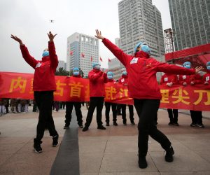 epa08282315 Medical workers celebrate the shutting down of Jianghan Fangcang temporary hospital for COVID-19 patients in Wuhan, Hubei province, China, 09 March 2020 (issued 10 March 2020). As the number of patients drops, the city has begun consolidating the temporary hospitals.  EPA/LI KE CHINA OUT