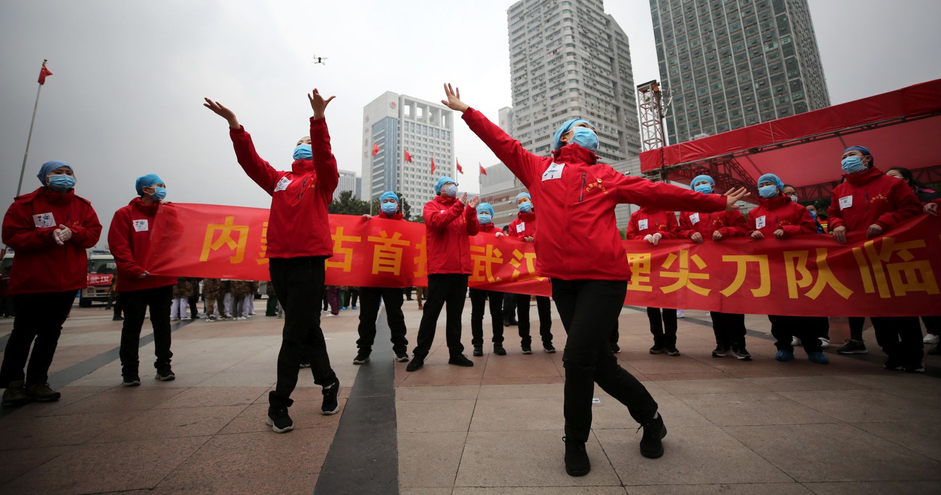 epa08282315 Medical workers celebrate the shutting down of Jianghan Fangcang temporary hospital for COVID-19 patients in Wuhan, Hubei province, China, 09 March 2020 (issued 10 March 2020). As the number of patients drops, the city has begun consolidating the temporary hospitals.  EPA/LI KE CHINA OUT