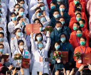 epa08285089 Medical staff celebrate after all patients were discharged at Wuchang Fangcang hospital, a temporary hospital set up at Hongshan gymnasium to treat people infected with the coronavirus and COVID-19 disease, in Wuhan, Hubei Province, China, 10 March 2020 (issued 11 March 2020). The temporary hospital closes on 10 March after China reported days of decline in the number of new coronavirus cases originating in the country. However, the number of coronavirus cases imported to China continued to rise, with 40 percent of the latest 24 infections reported on 11 March stemming from overseas.  EPA/YFC CHINA OUT