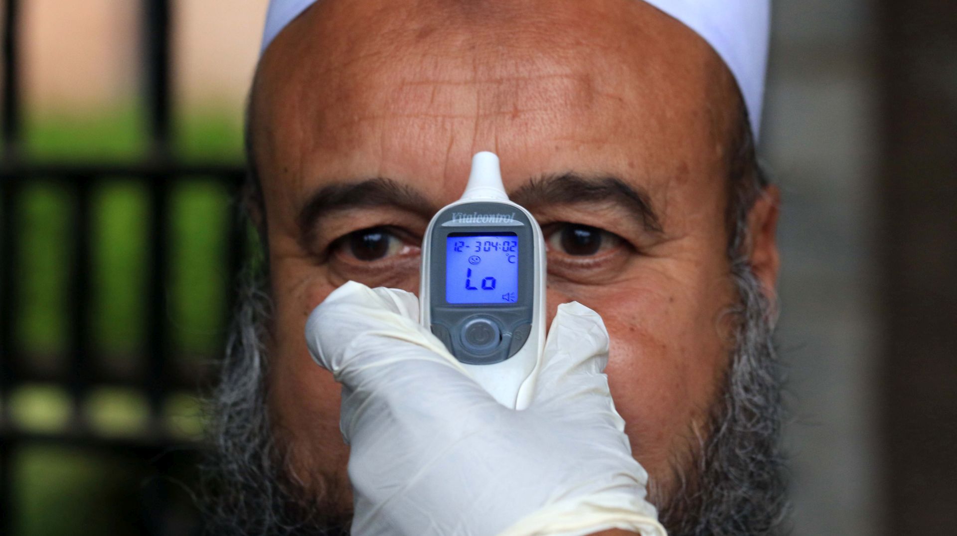 epaselect epa08287925 A Pakistani emergency services worker checks the body temperature of a person during preventive measures against the spread of coronavirus, which causes the disease COVID-19, in Peshawar, Pakistan, 12 March 2020. Pakistani authorities on 11 March confirmed two more ca?ses of coronavirus, bringing the toll to 20 patients as the World Health Organization (WHO) declared the outbreak a pandemic. The disease has spread to 114 countries, killed more than 4,300 people and infected more than 118,000, with the WHO warning these numbers were likely to increase.  EPA/BILAWAL ARBAB
