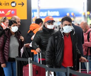 epa08293892 Travellers queue at Heathrow Airport in London, Britain, 14 March 2020. The future of British Airways and other airlines is under threat as global travel is significantly down due to the Coronavirus. The International Air Transport Association (IATA) on 13 March said losses of global airliners will likely exceed its earlier estimate of 113 billion US dollars.  EPA/ANDY RAIN
