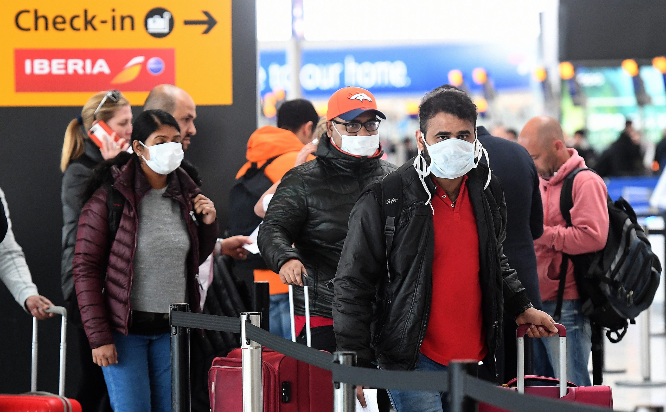 epa08293892 Travellers queue at Heathrow Airport in London, Britain, 14 March 2020. The future of British Airways and other airlines is under threat as global travel is significantly down due to the Coronavirus. The International Air Transport Association (IATA) on 13 March said losses of global airliners will likely exceed its earlier estimate of 113 billion US dollars.  EPA/ANDY RAIN