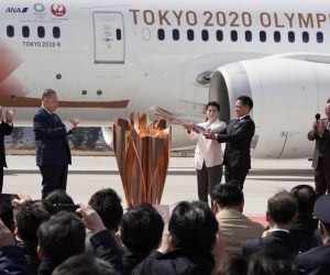 epa08308348 Japanese Olympic judo champion Tadahiro Nomura (5-L) and Olympic women's wrestling champion Saori Yoshida (4-L) light the Olympic flame on a cauldron during the Olympic flame arrival Ceremony at Japan Air Self-Defense Force Matsushima Air Base in Higashimatsushima, northern Japan, 20 March 2020. The Tokyo 2020 Olympic Flame Arrival Ceremony was scaled down over fears of coronavirus. Japanese Prime Minister Shinzo Abe is still considering holding the Tokyo Olympics as scheduled despite the current coronavirus pandemic.  EPA/KIMIMASA MAYAMA
