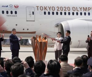 epa08308348 Japanese Olympic judo champion Tadahiro Nomura (5-L) and Olympic women's wrestling champion Saori Yoshida (4-L) light the Olympic flame on a cauldron during the Olympic flame arrival Ceremony at Japan Air Self-Defense Force Matsushima Air Base in Higashimatsushima, northern Japan, 20 March 2020. The Tokyo 2020 Olympic Flame Arrival Ceremony was scaled down over fears of coronavirus. Japanese Prime Minister Shinzo Abe is still considering holding the Tokyo Olympics as scheduled despite the current coronavirus pandemic.  EPA/KIMIMASA MAYAMA