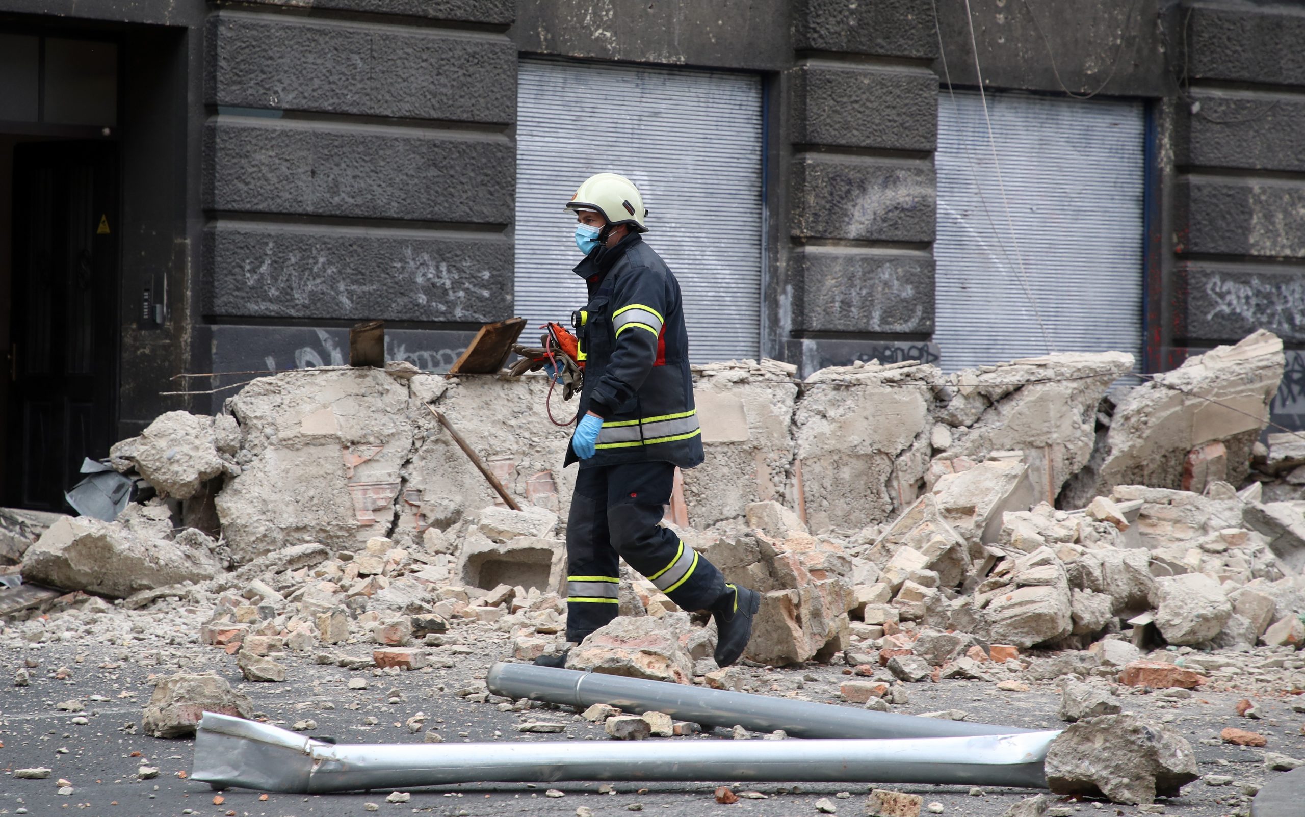 Zagreb, 22.03.2020 - Treci potres jakosti 3,7 potresao je u nedjelju ujutro u 7,41 sati Zagreb i okolicu. Dva snana potresa, prvi jakosti 5,3 drugi jakosti 5,0, pogodila su prije toga u nedjelju ujutro Zagreb i izazvala tete na zgradama. Na slici vatrogasac prolazi pored ruevina dijela zgrade u centru Zagreba.
foto HINA/ Damir SENCAR/ ds