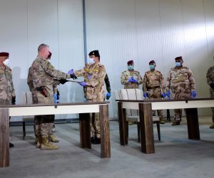 epa08330253 US Brigadier General Vincent B. Barker (2-L) shakes hand with an Iraqi army general during the handover ceremony of the K1 Air Base near Kirkuk city, northern Iraq, 29 March 2020. The US-led coalition forces withdrew from the third military bases in northern Iraq, amid heightened tensions with Iran-backed Iraqi Shiite armed groups in Iraq.  EPA/MURTAJA LATEEF