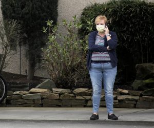 Woman talks on the phone at the Life Care Center of Kirkland, the long-term care facility linked to several confirmed coronavirus cases in the state, in Kirkland A woman talks on the phone at the Life Care Center of Kirkland, the long-term care facility linked to several confirmed coronavirus cases in the state, in Kirkland, Washington, U.S., March 7, 2020.  REUTERS/David Ryder DAVID RYDER