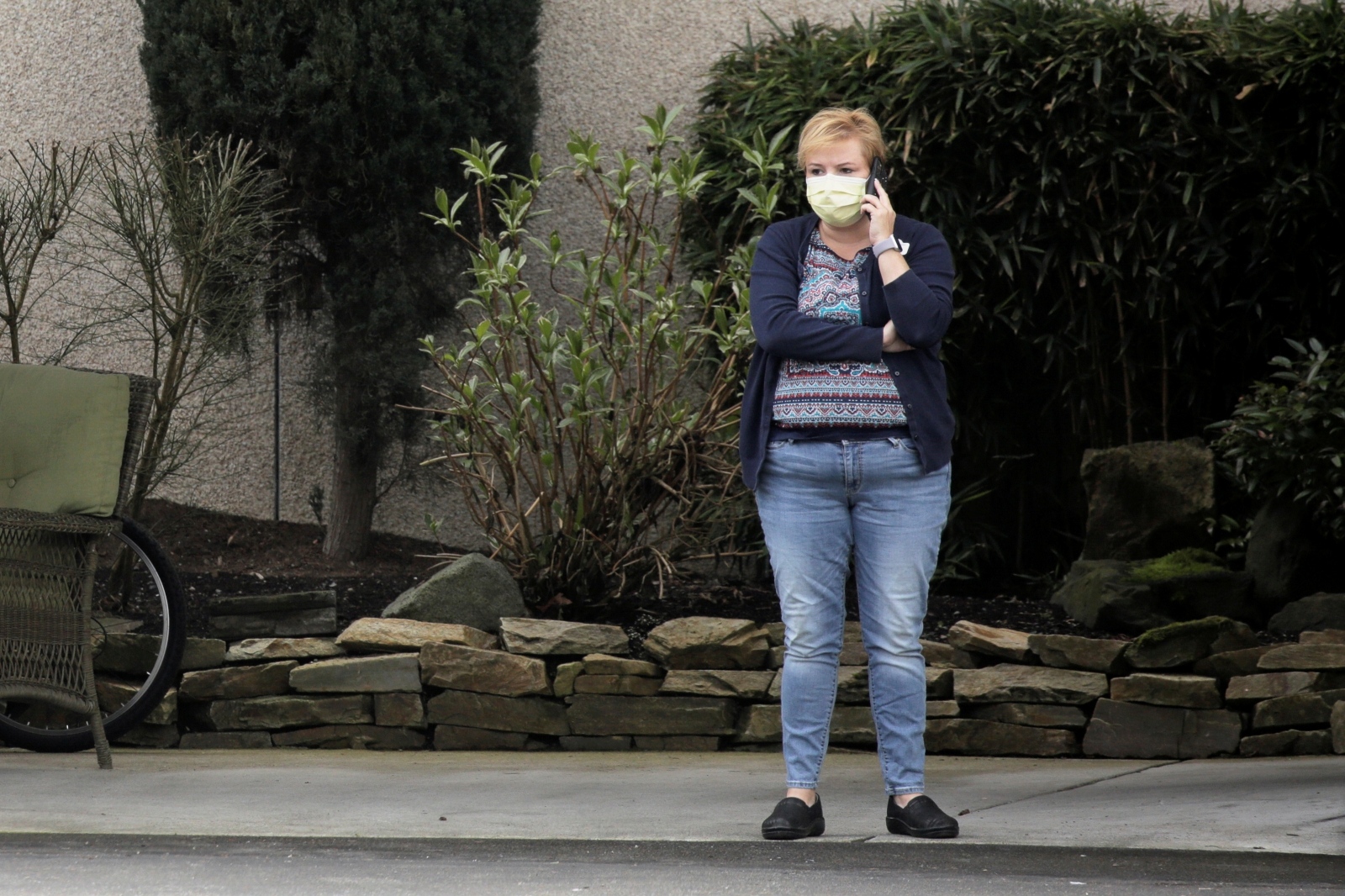 Woman talks on the phone at the Life Care Center of Kirkland, the long-term care facility linked to several confirmed coronavirus cases in the state, in Kirkland A woman talks on the phone at the Life Care Center of Kirkland, the long-term care facility linked to several confirmed coronavirus cases in the state, in Kirkland, Washington, U.S., March 7, 2020.  REUTERS/David Ryder DAVID RYDER