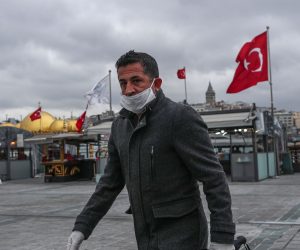 epa08321968 A man with a face mask and gloves walks in empty streets in Istanbul, Turkey, 25 March 2020. Turkish Health Minister Koca said on 24 March that there are 1,872 confirmed cases of the coronavirus and 44  related deaths from COVID-19. Turkey decided to halt public events, temporarily shut down schools and suspend sporting events in an attempt to prevent further spreading of the coronavirus.  EPA/SEDAT SUNA