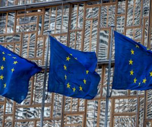 epa08324059 A view of EU flags next to the European Council in Brussels, Belgium, 26 March 2020. EU leaders will debate the coordination of EU efforts to tackle the Covid-19 epidemic, as well as other issues, including foreign affairs, digital policy and enlargement.  EPA/STEPHANIE LECOCQ