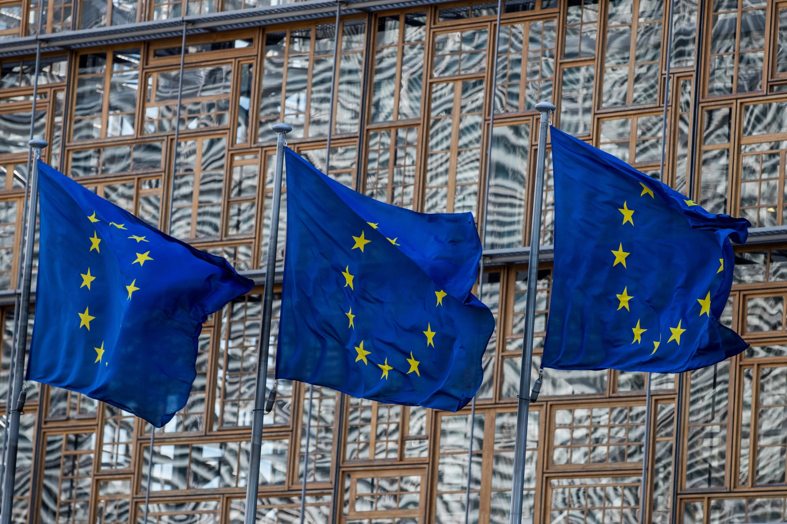epa08324059 A view of EU flags next to the European Council in Brussels, Belgium, 26 March 2020. EU leaders will debate the coordination of EU efforts to tackle the Covid-19 epidemic, as well as other issues, including foreign affairs, digital policy and enlargement.  EPA/STEPHANIE LECOCQ