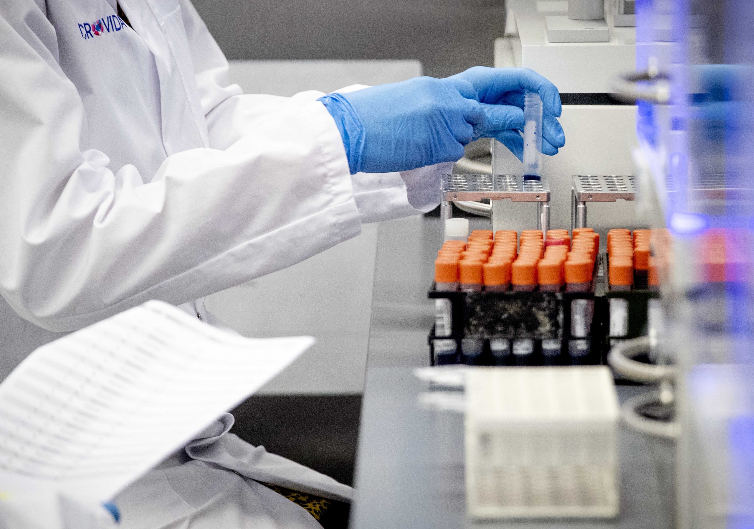 epa08335045 A staff member wearing protective gloves works in the Microvida medical laboratory, at Bravis hospital in Roosendaal, The Netherlands, 31 March 2020. The laboratory conducts tests for the novel coronavirus diseases (COVID-19).  EPA/SEM VAN DER WAL