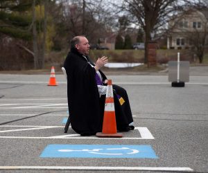 epa08337716 Father Corey Bassett-Tirrell hears a parishioner's confession in the parking lot of St Mary's Church in Chelmsford, Massachusetts, USA, 01 April 2020. Weather dependent, confessions will be heard in the parking lot on Wednesday's from 4 to 6pm until the closure on the Church due to the pandemic is lifted. Countries around the world have closed borders, schools as well as public facilities, and have cancelled most major sports and entertainment events in order to stem the spread of the SARS-CoV-2 coronavirus causing the Covid-19 disease.  EPA/CJ GUNTHER