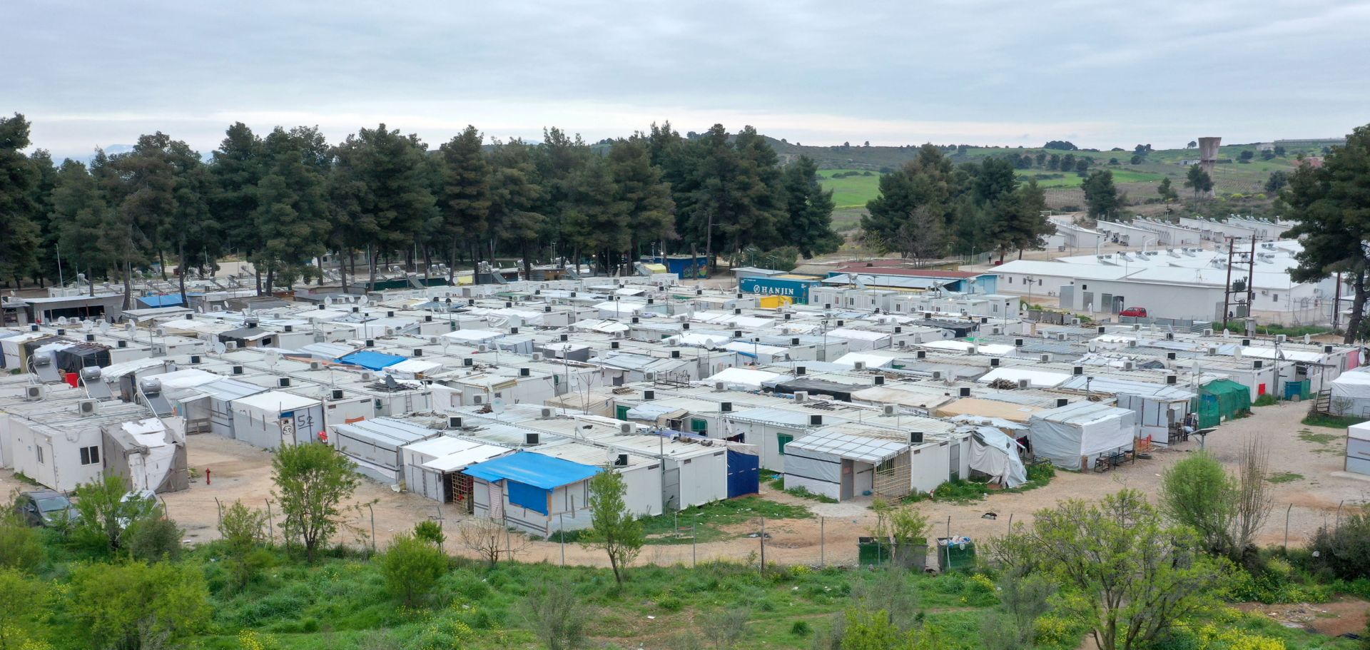 epa08340581 A photograph taken with a drone shows the refugee camp of Ritsona, north of Athens, Greece, 03 April 2020. Deputy Minister for Civil Protection and Crisis Management Nikos Hardalias confirmed on 03 April 2020 that the Ritsona refugee and asylum-seekers facility has been placed on lockdown for the next 14 days as of Thursday morning, after 23 residents so far tested positive for the novel coronavirus.At Ritsona camp lives 2.800 people.  EPA/ANDREAS TSAKNARIDIS