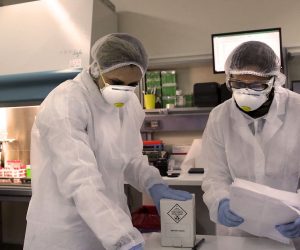 epa08347310 Microbiologists at the Hellenic Pasteur Institute work in the institute's 3rd-level biosafety laboratory, which performs tests to detect the presence of the novel SARS-CoV-2 coronavirus that causes the pandemic COVID-19 disease, in Athens, Greece, 06 April 2020 (issued 07 April 2020).  EPA/ORESTIS PANAGIOTOU