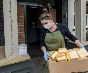 epa08359528 A volunteer delivers a food parcel including an Easter egg in Liverpool, Britain, 12 April 2020.
The Horse and Jockey is a pub in Melling, Liverpool were the owners and volunteers have been making 80-100 dinners a day and delivering them to the elderly who are unable to leave their houses during the Covid 19 pandemic.  EPA/PETER POWELL