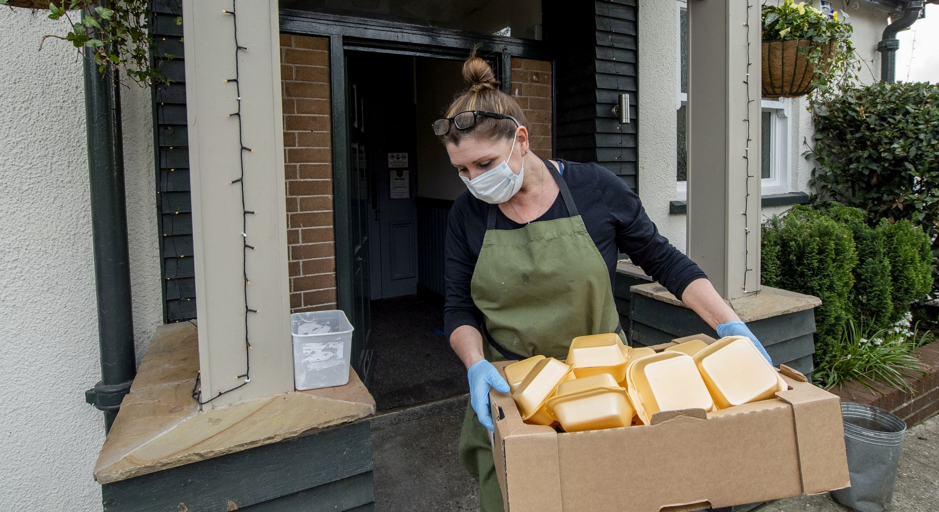 epa08359528 A volunteer delivers a food parcel including an Easter egg in Liverpool, Britain, 12 April 2020.
The Horse and Jockey is a pub in Melling, Liverpool were the owners and volunteers have been making 80-100 dinners a day and delivering them to the elderly who are unable to leave their houses during the Covid 19 pandemic.  EPA/PETER POWELL