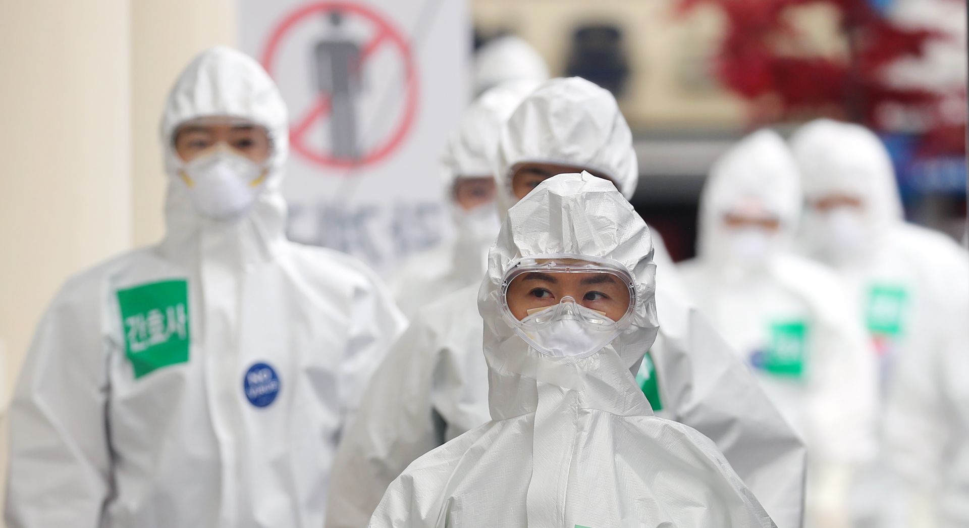 epa08359885 Medical workers in protective gear walk to wards, for COVID-19 patients, before their work shift at Dongsan Hospital in Daegu, South Korea, 13 April 2020.  EPA/YONHAP SOUTH KOREA OUT