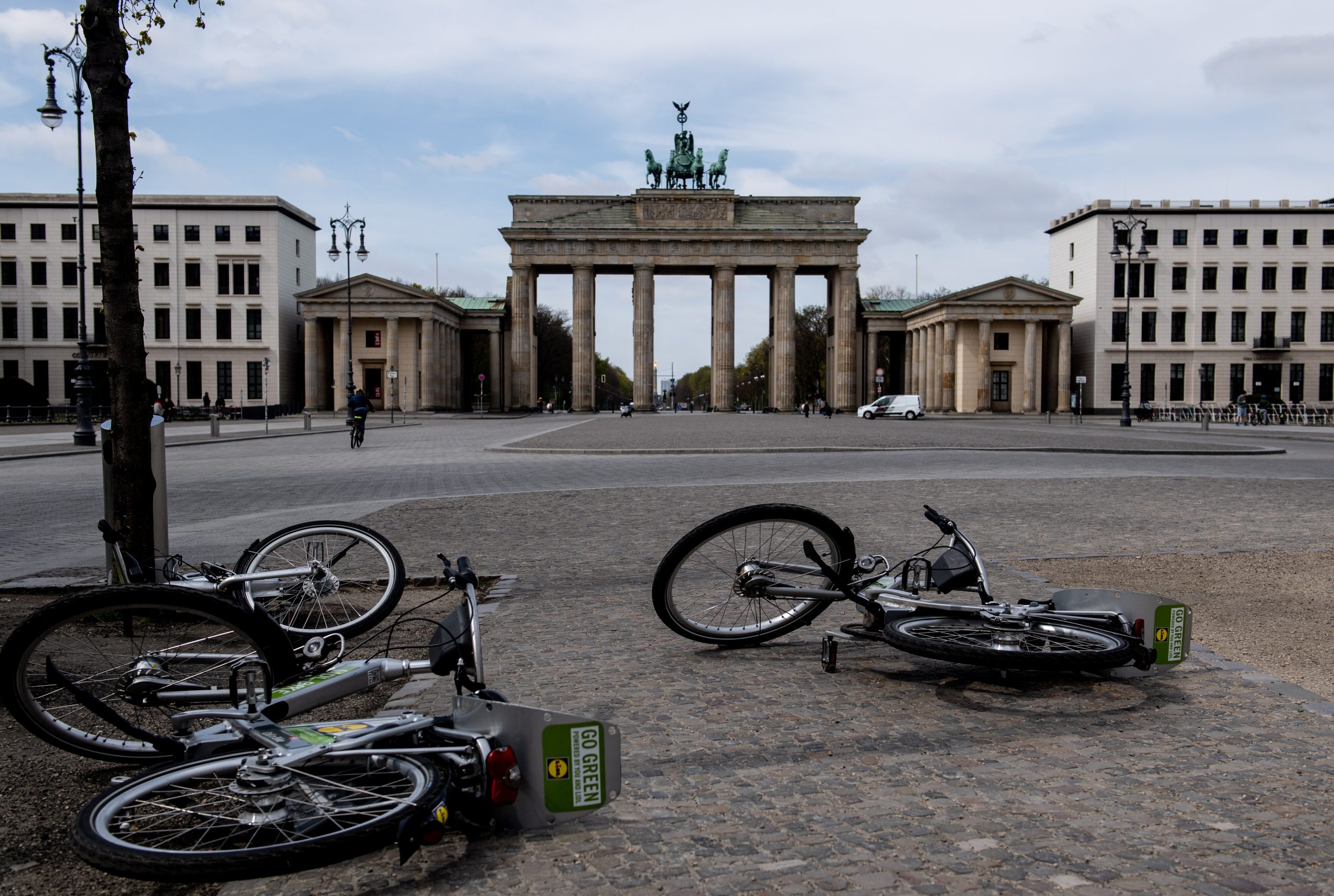epa08364337 A view of fallen rental bicycles near the Brandenburg Gate in the empty Pariser Platz in Berlin, Germany, 15 April 2020. The popular tourist attraction site stands almost empty from visitors these days. The German government and local authorities are heightening measures to stem the spread of the coronavirus SARS-CoV-2 which causes the COVID-19 disease. The so called 'social distancing' restrictions should remain in effect until 19 April.  EPA/FILIP SINGER