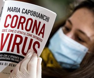 epa08372647 People wear the protective mask inside a book store during the emergency blockade of the Coronavirus Covid-19 in Rome, Italy, 20 April 2020. Italy has begun partially lifting the coronavirus lockdown in three macro areas. The measures will be evaluated after 15 days to see if containment measures are working.  EPA/ANGELO CARCONI