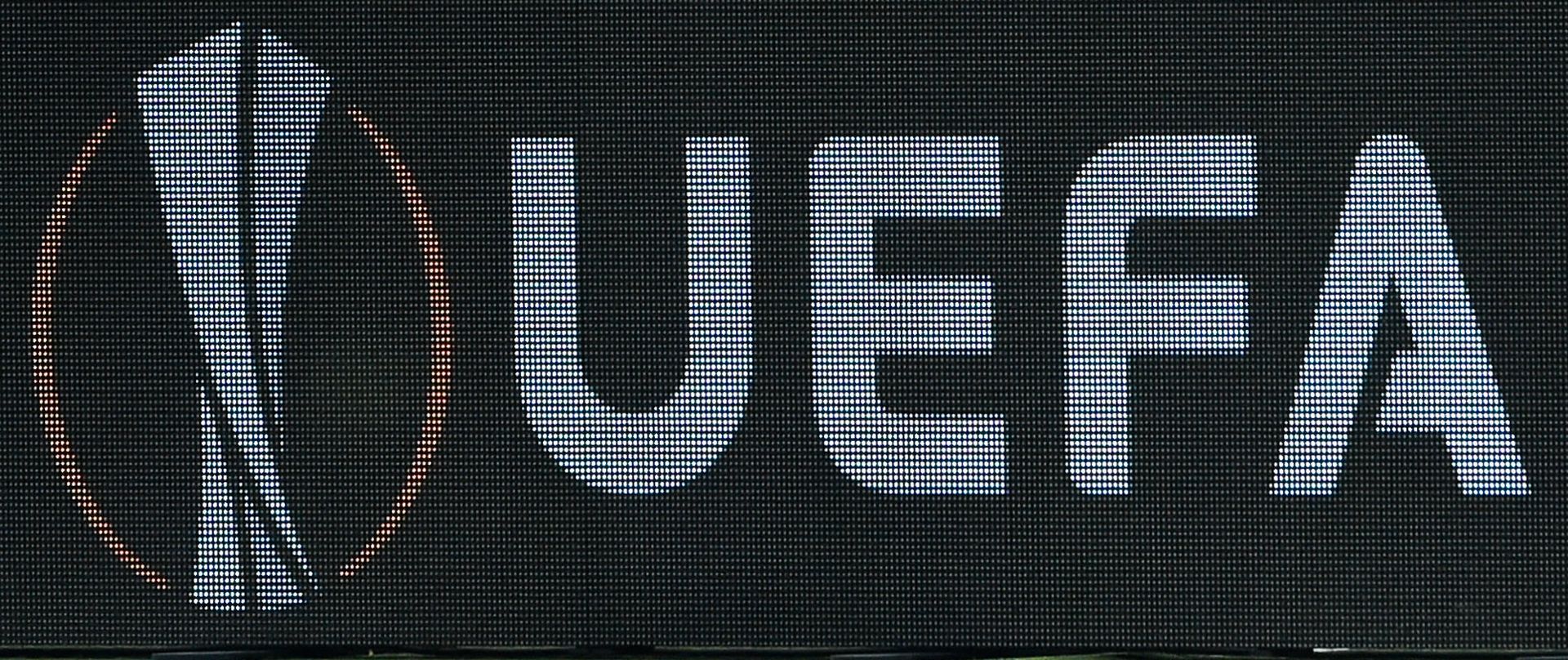 FILED - 29 November 2018, Hessen, Frankfurt_Main: The UEFA logo displayed on an advertising board during the UEFA Europa League Group H soccer match between Eintracht Frankfurt and Olympique Marseille at the Commerzbank-Arena. UEFA on Tuesday reiterated its recommendation to members to complete their leagues amid the coronavirus pandemic but is seemingly also ready to look into possible cancellations in certain circumstances. Photo: Silas Stein/dpa