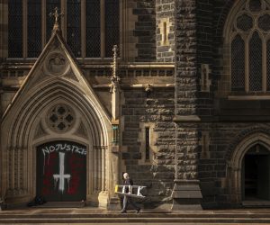 epaselect epa08349614 A worker arrives to cover graffiti at St Patrick's Cathedral in Melbourne, Australia, 08 April 2020. Melbourne's St Patrick's Cathedral was vandalized overnight to protest against the acquittal of Australian Cardinal George Pell. Australia on 07 April acquitted former Vatican finance chief, Cardinal George Pell, of historical child sex-abuse charges.  EPA/DANIEL POCKETT AUSTRALIA AND NEW ZEALAND OUT