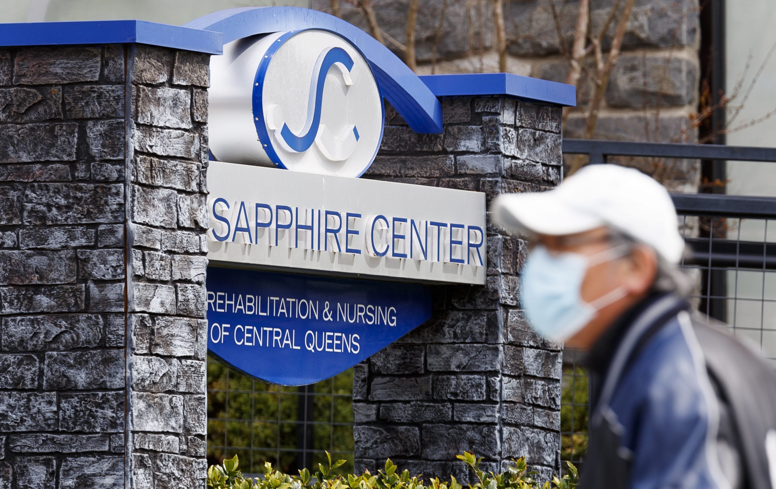epa08369814 A man walks past the Sapphire Center for Rehabilitation and Nursing of Central Queens in Queens, New York, USA, on 17 April 2020. Twenty-nine residents at the nursing home have been confirmed to have died between 01 March and 15 April, but according to news reports, as many as 60 residents may have died as a result of the coronavirus at the 227-bed facility.  EPA/JUSTIN LANE