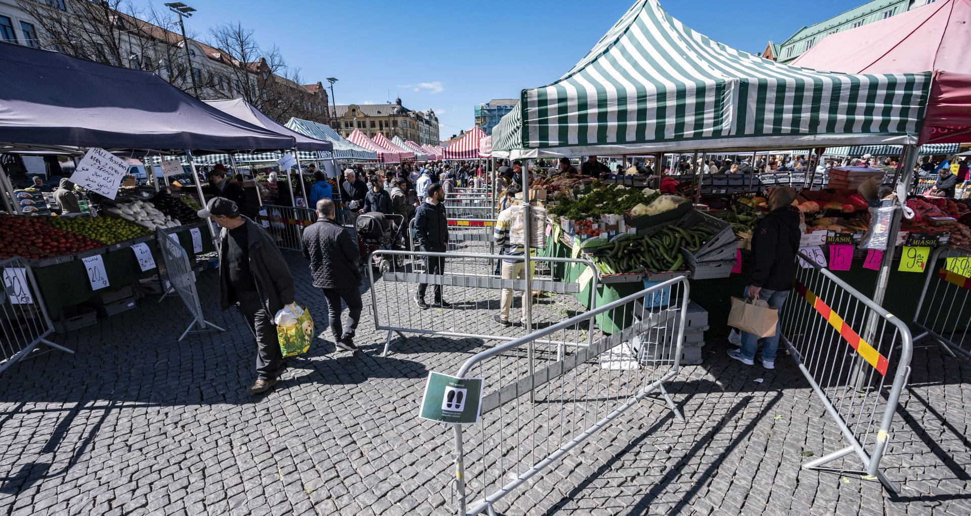 epa08384578 People walk at a market as the City of Malmo has placed fences and information to reduce congestion at the stands, due to the coronavirus pandemic, in Malmoe, Sweden, 25 April 2020. While many countries in Europe have instituted a lockdown in a bid to slow down the spread of the ongoing COVID-19 pandemic, Sweden has taken a far less drastic approach; for example, allowing primary schools to remain open as well as bars and restaurants as long as they limit all service to table service only.  EPA/Johan Nilsson SWEDEN OUT