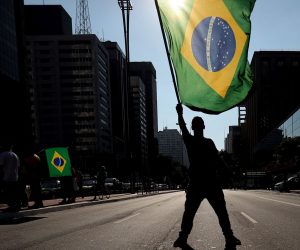 epaselect epa08385739 Protesters participate in a demonstration against social isolation, along with supporting a military intervention in the country, in Sao Paulo, Brazil, 26 April 2020. According to media reports, Brazilian President Jair Bolsonaro, supported protesters and spoke to a group of supporters who advocated the closure of Congress and a military intervention in Brazil.  EPA/FERNANDO BIZERRA