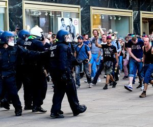 epa08412195 Right wing protestors attack police officers during a gathering on the Alexanderplatz in Berlin, Germany, 09 May 2020. According to a spokesperson of the Berlin police a group of people moved from the surrounding of the so-called 'hygiene demonstration' at the Volksbuehne at Rosa-Luxemburg-Platz to Alexanderplatz. As moving in bigger groups still is prohibited due to the covid-19 security measures police started detaining participants at Alexanderplatz. The motivation of the people to gather was unclear.  EPA/FILIP SINGER