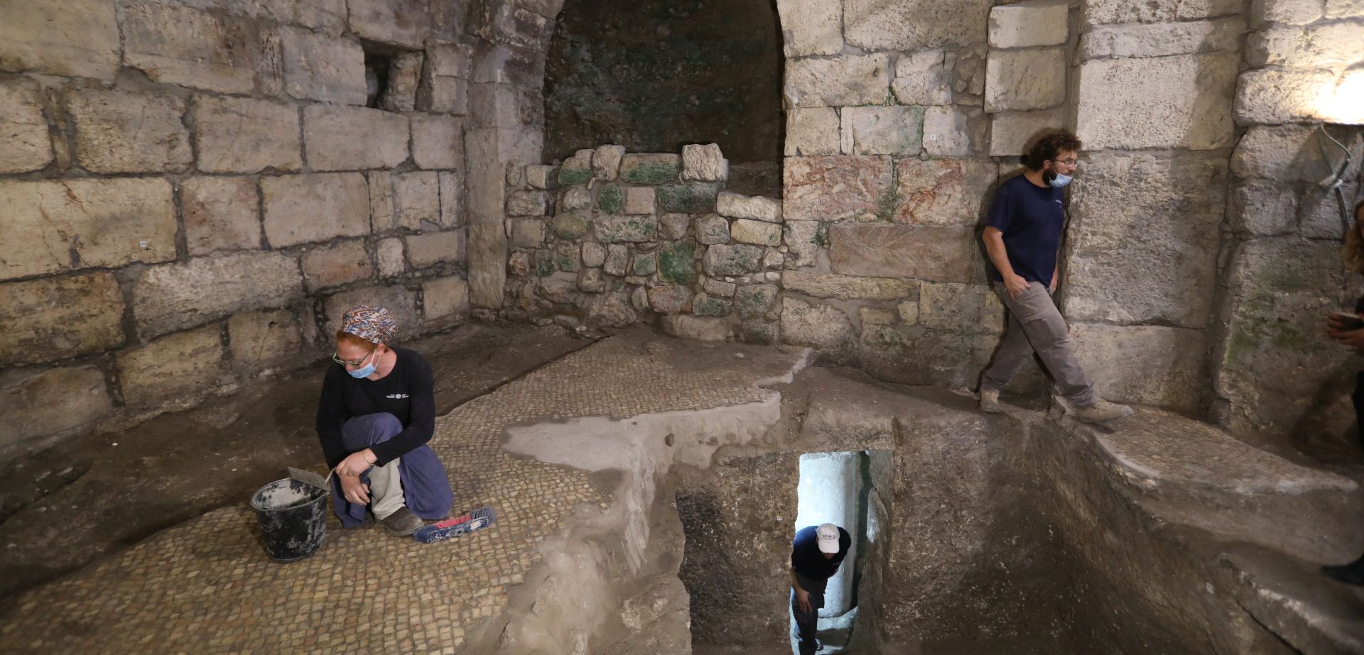 epa08431410 Israeli archaeologists work at an archeological excavation site in the Western Wall Tunnels,  Jerusalem, 19 May 2020. The Israel Antiquities Authority said archaeologists discovered an unique subterranean system hewn in the bedrock from the Second Temple period beneath a1400-year-old public building in the underground excavations under the Western Wall.  EPA/ABIR SULTAN