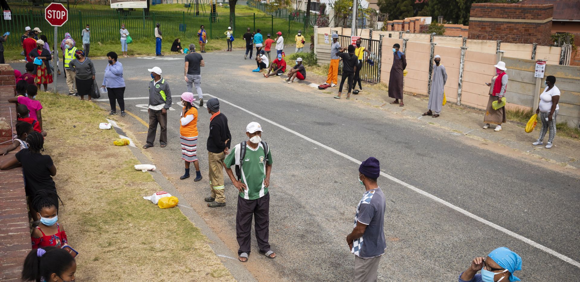 epa08431766 Local residents line up patiently during a food handout by 'Hunger has no religion group' in Carination on day 53 of the national lockdown as a result of Covid-19 Coronavirus, in Johannesburg, South Africa, 19 May 2020. The origination feeds 1,500 people per day for six days a week. Food insecurity is one of the main issues facing the country since the start of lockdown. The country is at level 4 of the national lockdown in its 46 day after it was implemented on 30 April 2020.  EPA/KIM LUDBROOK