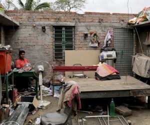epa08435246 A cyclone victim sits in his house without a roof after Cyclone Amphan made landfall, in Bokkhali village near the Bay of Bengal, India, 21 May 2020. The Odisha government and Bengal government are considering a mass evacuation of the area.  EPA/PIYAL ADHIKARY