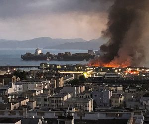 epa08440142 A handout photo made available by Courtesy of Edward Emery shows more than 100 San Francisco Firefighters battle a four-alarm fire on Pier 45 on Fisherman's Wharf as a cargo ship passes by in San Francisco, California, USA, 23 May 2020. Firefighters stationed a fireboat to protect the World War II-era SS Jeremiah O'Brien (Behind flames) from any damage.  EPA/EDWARD EMERY / HANDOUT  HANDOUT EDITORIAL USE ONLY/NO SALES
