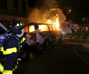 epa08455395 New York City firefighters spray water on a police van set ablaze by protesters during protests over the Minneapolis arrest of George Floyd, who later died in police custody, in Harlem, New York, USA, 30 May 2020. A bystander's video posted online on 25 May, appeared to show George Floyd, 46, pleading with arresting officers that he couldn't breathe as an officer knelt on his neck. The unarmed Black man later died in police custody. On 29 May, Derek Chauvin, the police officer in the center of the incident has been taken into costody and charged with murder in the Floyd arrest.  EPA/PETER FOLEY