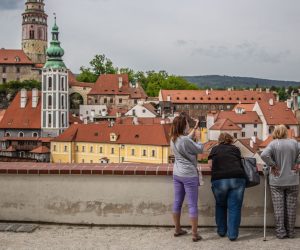 epa08438219 People look down at almost empty vantage point above the old town of Cesky Krumlov, UNESCO World Culture Heritage site, Czech Republic, 22 May 2020. According to local media, more than 15.000 tourists from Asia arrived in the South Bohemian region, where is located the popular tourist destination Cesky Krumlov, on January 2020. Due to the pandemic COVID-19 disease caused by the SARS-CoV-2 coronavirus, which closed borders and restricted travel, the number of accommodated tourists in southern Bohemia fell by 30 percent in the first quarter. The region is the most affected in the country.  EPA/MARTIN DIVISEK