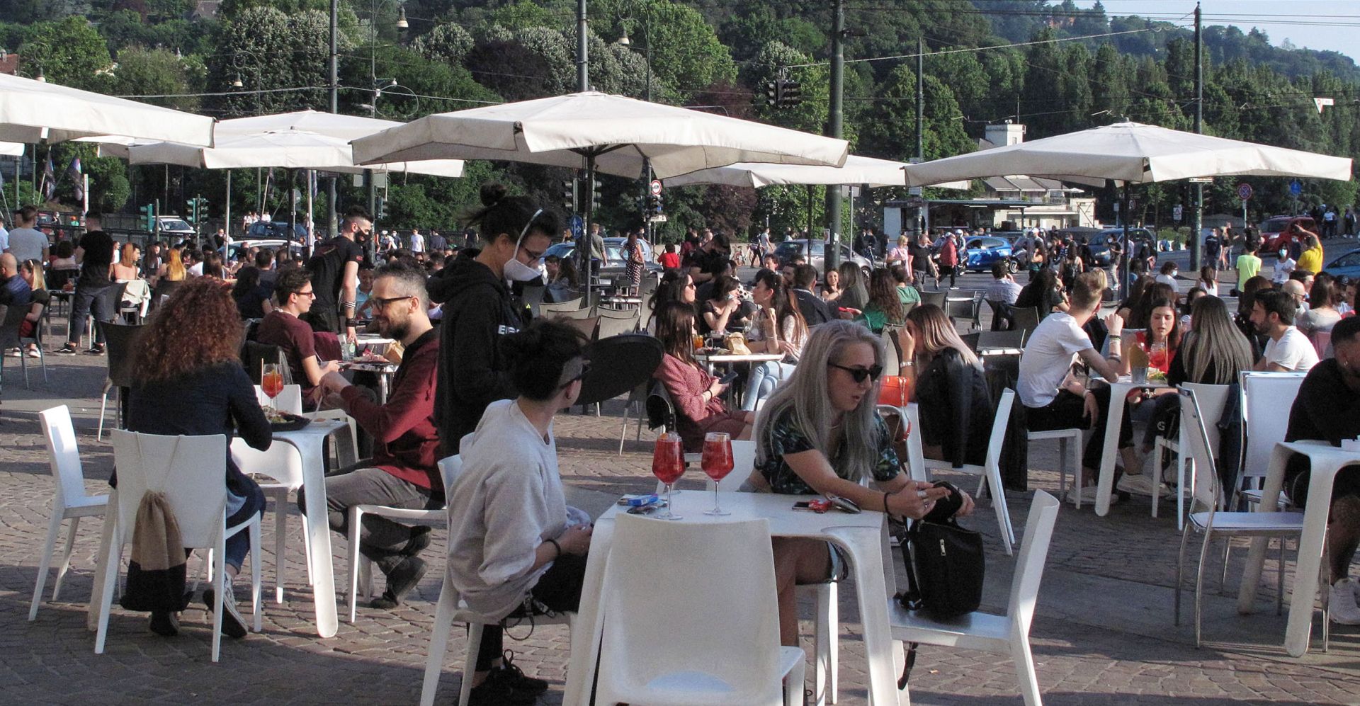 epa08456553 People sit at the tables located outside the bars in the center of Turin, during Phase 2 of the emergency Covid-19, Turin, Italy, 31 May 2020.  EPA/ALESSANDRO DI MARCO