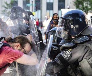 epaselect epa08459220 Officers pepper spray a protester while pushing him back during a demonstration over the death of George Floyd, who died in police custody, near the White House in Washington, DC, USA, 01 June 2020. A bystander's video posted online on 25 May, shows George Floyd, 46, pleading with arresting officers that he couldn't breathe as one officer knelt on his neck. The unarmed black man soon became unresponsive, and was later pronounced dead. According to news reports on 29 May, Derek Chauvin, the police officer in the center of the incident has been taken into custody and charged with murder in the George Floyd killing.  EPA/SAMUEL CORUM