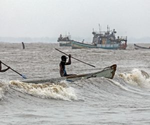 epa08462061 Indian fishermen arrives at the Arabian sea shore, at the Uttan village, near Mumbai, India, 03 June 2020. The India Meteorological Department (IMD) has advised fishermen not to venture out to sea along the coast of Maharashtra as a precaution against approaching tropical cyclone Nisarga. The cyclone Nisarga will landfall in Mumbai on 03 June 2020.  EPA/DIVYAKANT SOLANKI