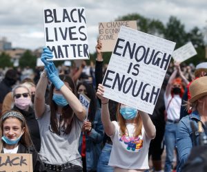 epa08471438 Protesters hold placards during a 'Black Lives Matter' (BLM) demonstration at Glasgow Green, Glasgow, Britain, 07 June 2020. Thousands of people defy the coronavirus lockdown order to take part in the anti-racism demonstration held to condemn the killing of George Floyd, a 46-year-old African-American man who died on 25 May after being detained by police officers in Minneapolis (Minnesota), USA, and to express solidarity with the BLM-led protests currently taking place throughout the US.  EPA/ROBERT PERRY