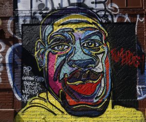 epa08475019 A graffiti painting of George Floyd by graffiti artist Fumeroism is depicted on a side of a building on the Lower East Side in New York, New York, USA, 09 June 2020. A bystander's video posted online on 25 May, appeared to show George Floyd, 46, pleading with arresting officers that he couldn't breathe as an officer knelt on his neck. The unarmed Black man later died in police custody and all four officers involved in the arrest have been charged and arrested.  EPA/JASON SZENES