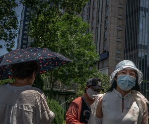 epa08480249 People wearing protective face masks walk in Beijing, China, 12 June 2020. Beijing confirmed on 11 June its first locally transmitted case of COVID-19 after over 50 days without a local transmission.  EPA/ROMAN PILIPEY