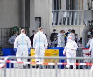 epa08497278 A handout photo made available by the German armed forces (Bundeswehr) shows soldiers taking coronavirus tests from workers at the Toennies meat factory in Rheda-Wiedenbrueck, western Germany, 19 June 2020 (issued 20 June 2020). According to media reports, more than 800 Toennies workers at the Rheda-Wiedenbrueck plant – Europe's largest slaughterhouse – have tested positive for the SARS-CoV-2 coronavirus that causes the COVID-19 disease, making it one of the largest clusters of the ongoing pandemic detected so far in the country.  EPA/KORTE / BUNDESWEHR / HANDOUT  HANDOUT EDITORIAL USE ONLY/NO SALES
