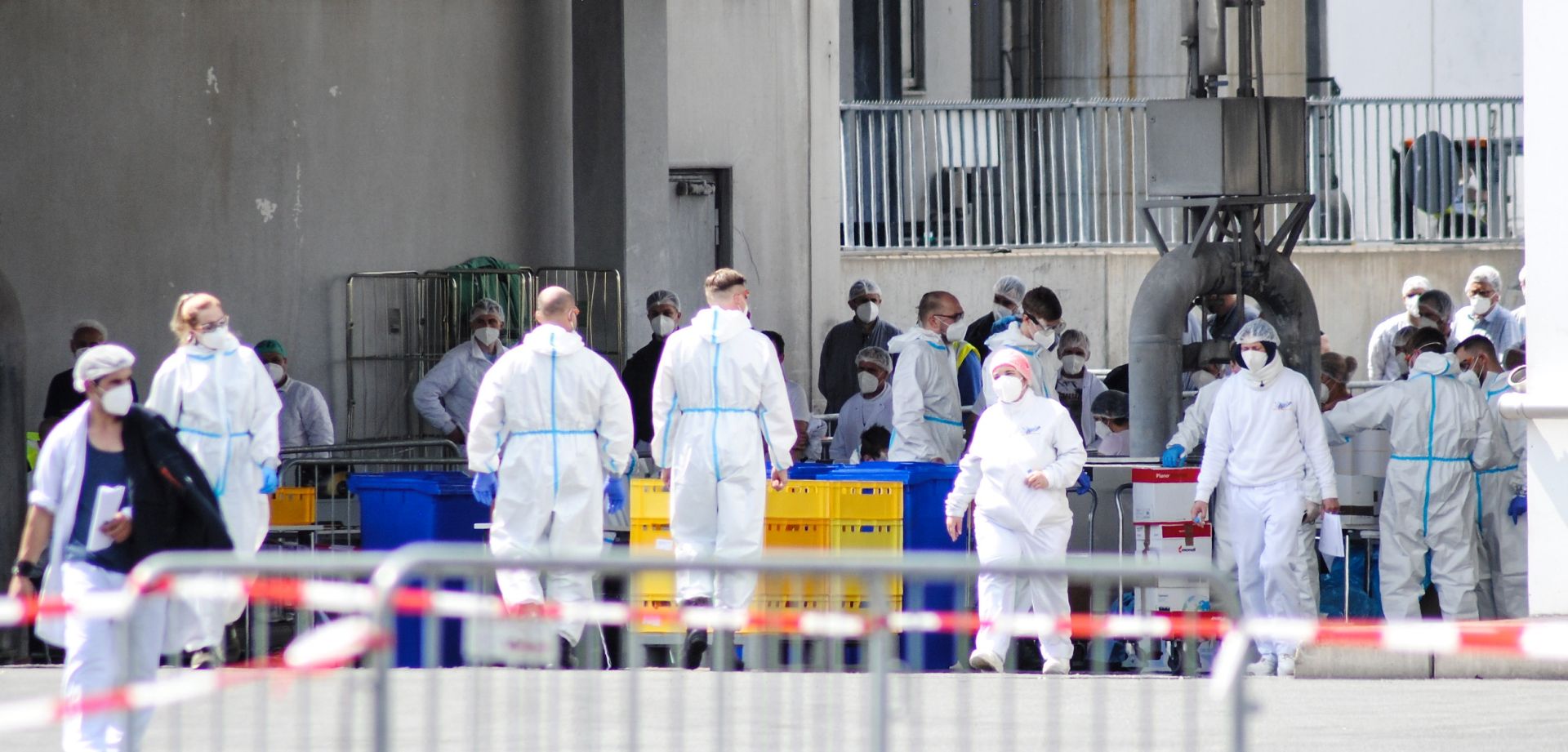 epa08497278 A handout photo made available by the German armed forces (Bundeswehr) shows soldiers taking coronavirus tests from workers at the Toennies meat factory in Rheda-Wiedenbrueck, western Germany, 19 June 2020 (issued 20 June 2020). According to media reports, more than 800 Toennies workers at the Rheda-Wiedenbrueck plant – Europe's largest slaughterhouse – have tested positive for the SARS-CoV-2 coronavirus that causes the COVID-19 disease, making it one of the largest clusters of the ongoing pandemic detected so far in the country.  EPA/KORTE / BUNDESWEHR / HANDOUT  HANDOUT EDITORIAL USE ONLY/NO SALES